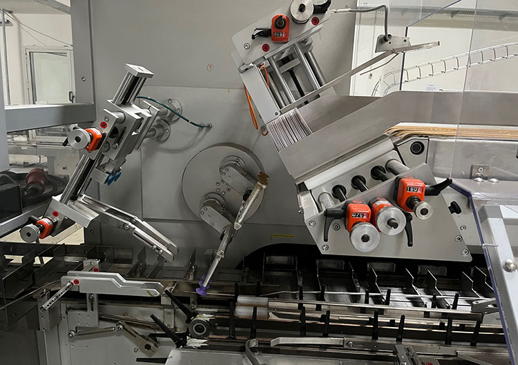 Flat cartons being fed into the machine