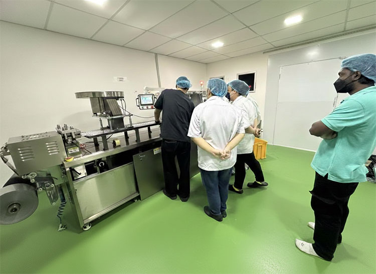 Technician installing blister machine in factory
