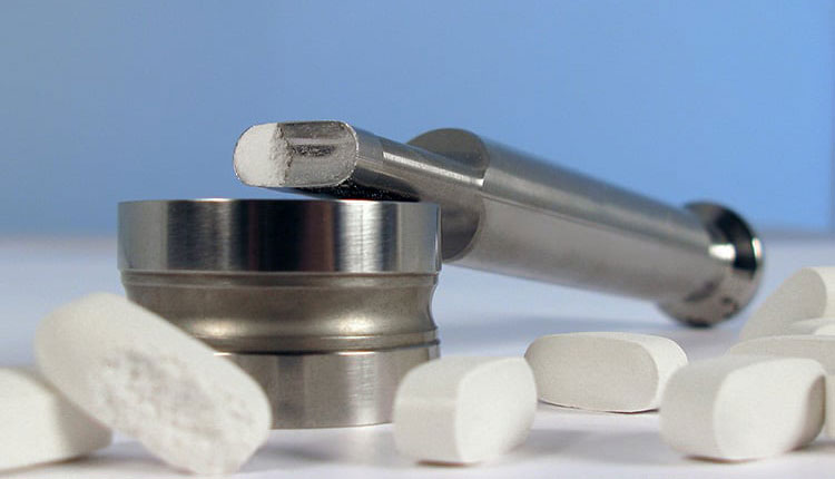 Sticky ibuprofen tablet powder on punch